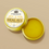 Thumbnail: yellow arnica relief balm in a gold tin