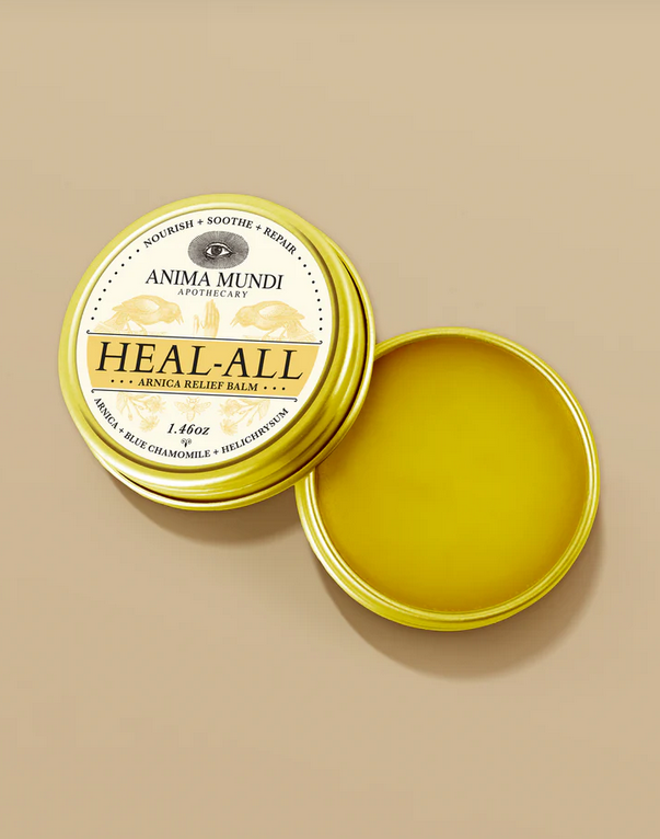 yellow arnica relief balm in a gold tin