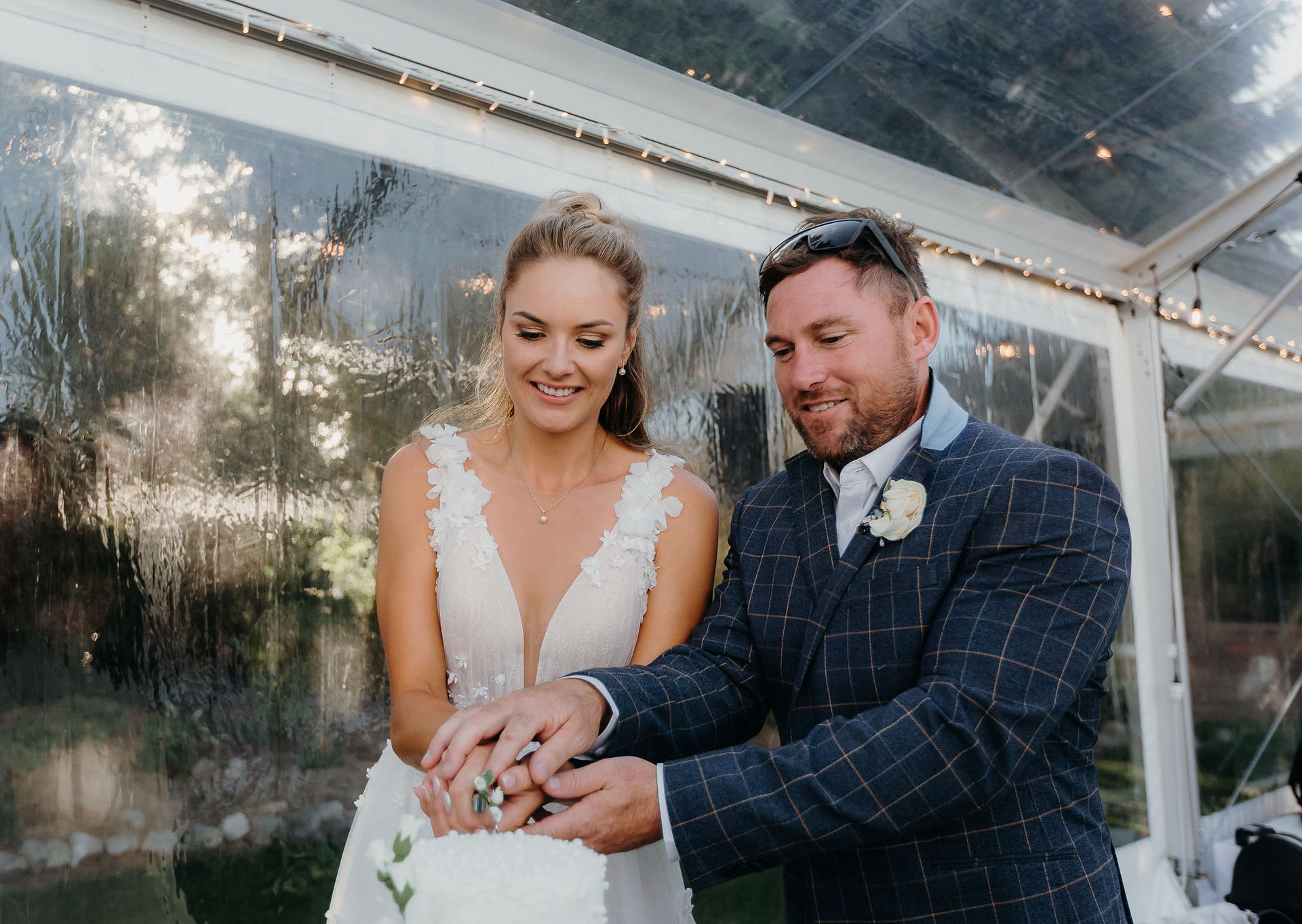 bride and groom cut wedding cake