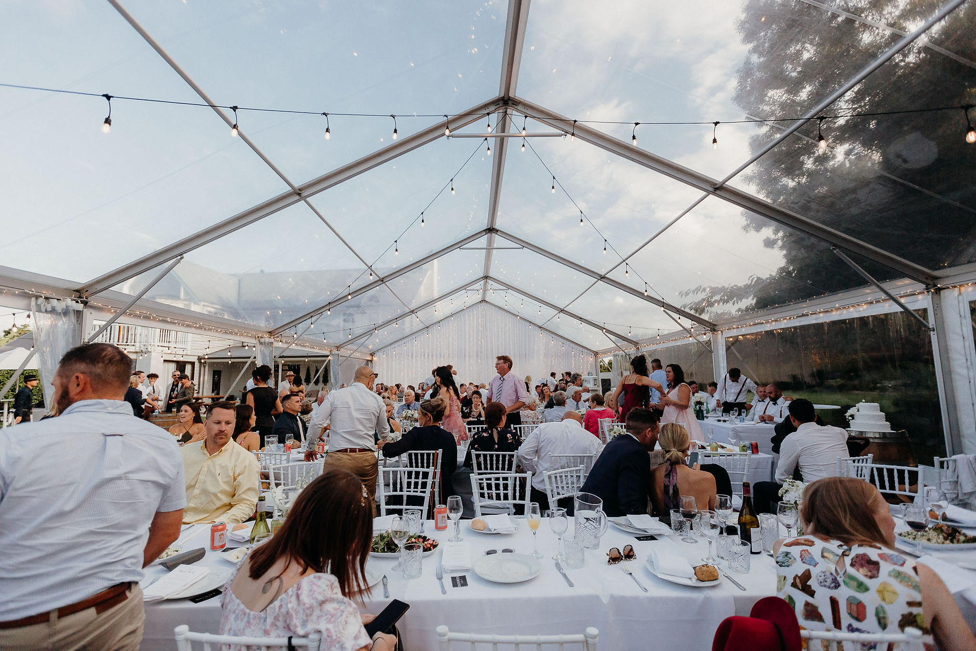 Speeches and dinner inside a clear marquee in Canterbury