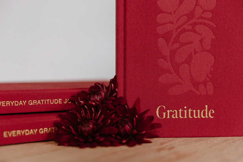 Thumbnail: red white and blue covers of gratitude journal by olive and page