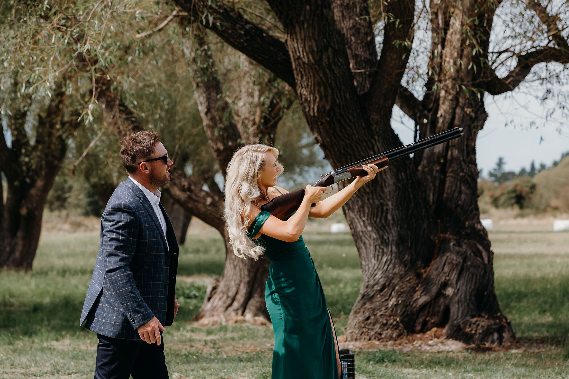 Bride and groom clay bird shooting with their bridal party before the wedding ceremony
