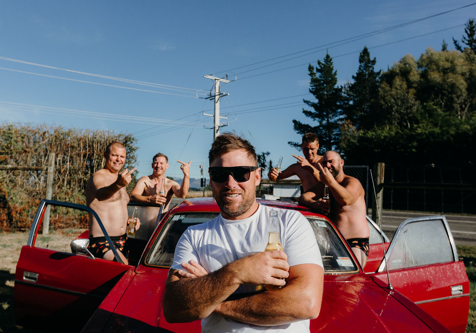 Groom and groomsmen with a classic Chrysler before a Canterbury wedding