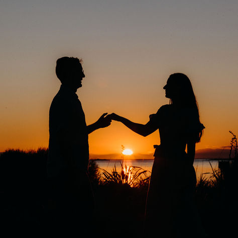 sunset engagement photoshoot with couple silhouetted against the sunset