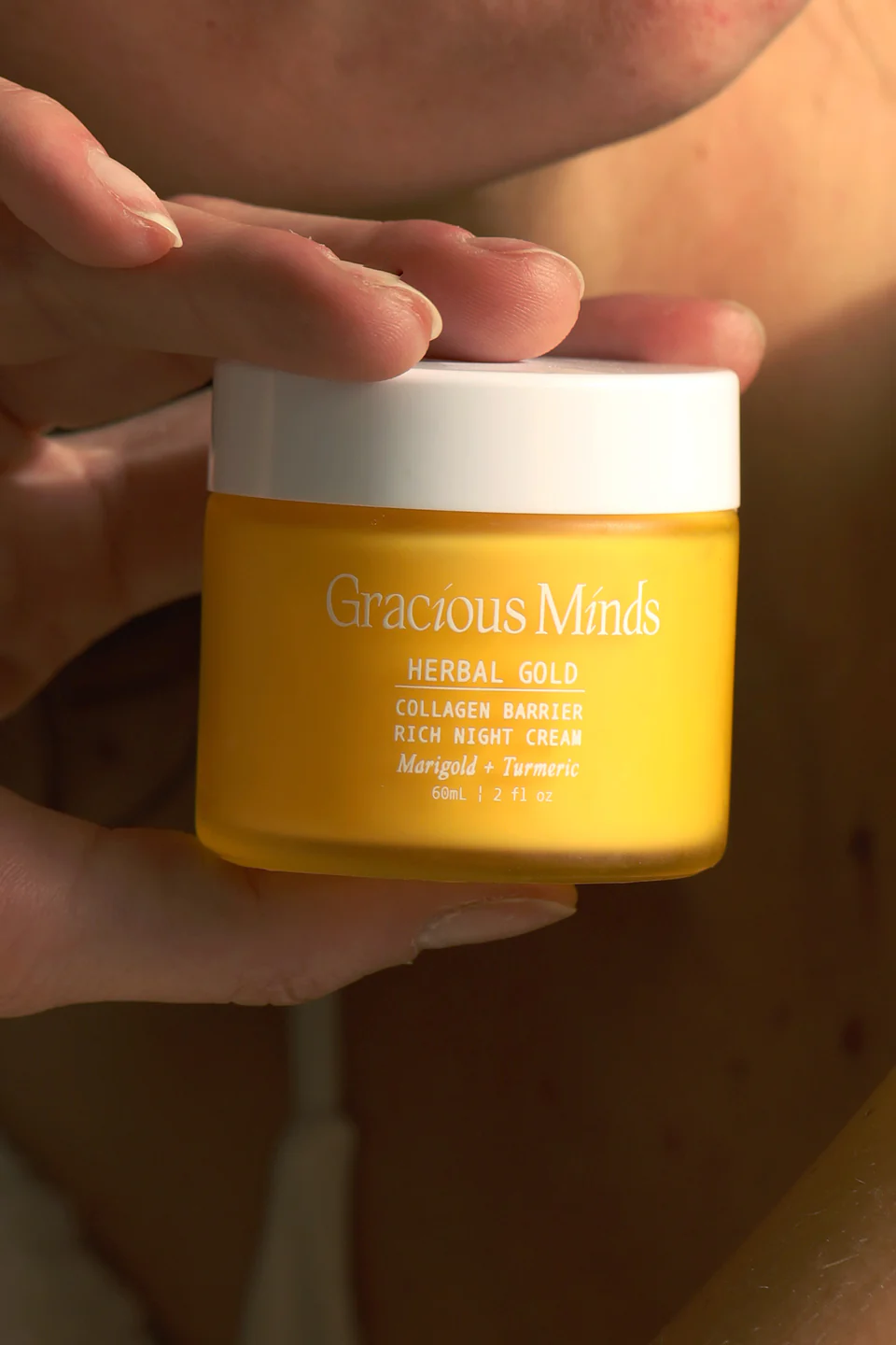 A glass jar of golden-hued 'Herbal Gold' night treatment. Contains Australian Bush Tomato and Turmeric