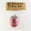Thumbnail: a red cartoonish looking strawberry with green calyx cap stress ball