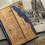 Thumbnail: journal on a desk with image behind it