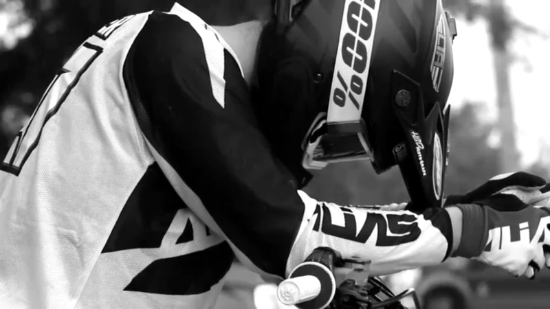 Motocross rider preparing on race day wearing helmet before moto start