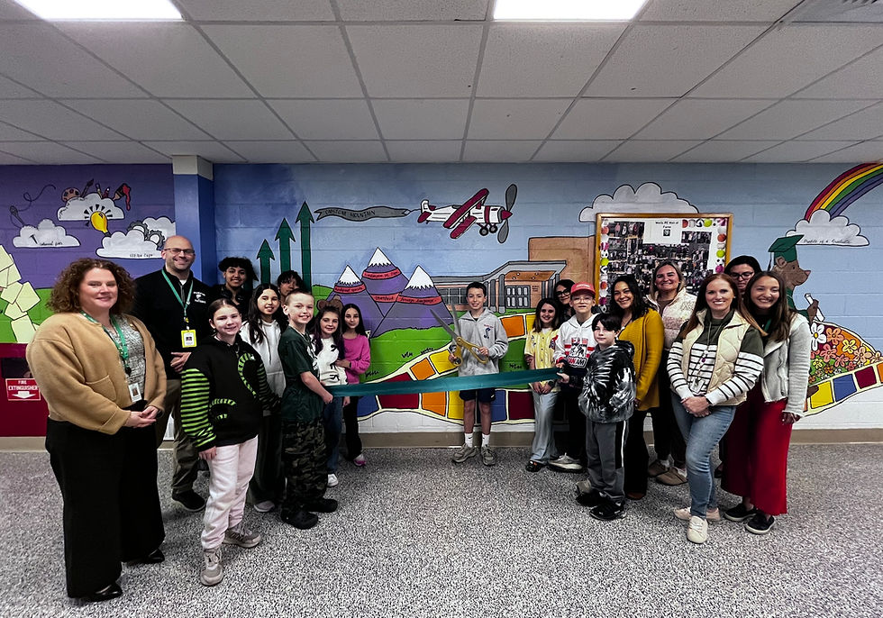 Students and staff cut the ribbon to officially debut the new mural on the corridor that connects C.V. Starr and H.H. Wells schools. 
