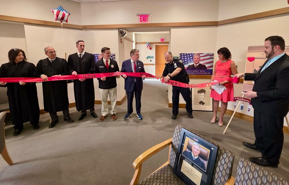 Local and state lawmakers gather with members of the New York State Office of Court Administration and representatives from the 9th Judicial District, along with Barbara Reitz, to honor her late husband and former Putnam County Court Judge James Reitz as they celebrate the renaming of the courtroom where he presided.