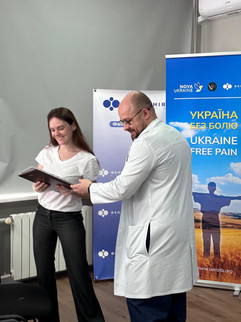 Ukrainian doctors receiving certificates after completing pain syndrome treatment course through Ukraine Without Pain initiative