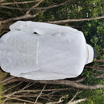 The back of a men's white cotton shirt on a mannequin in the bush at Pakawau. 
