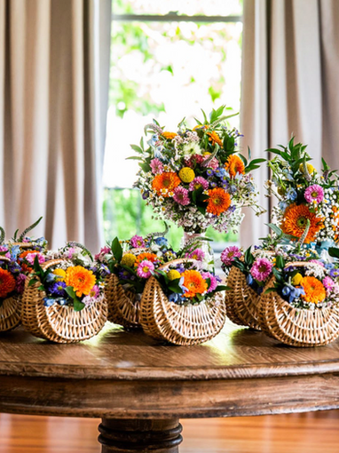 Beautiful bridesmaid baskets and bridal bouquet with wildflowers and daisies.