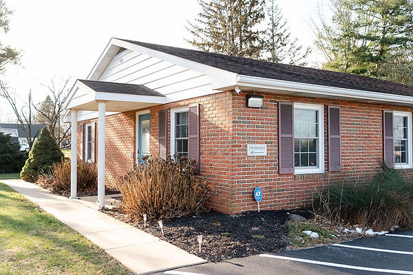 One story brick building with sidewalk