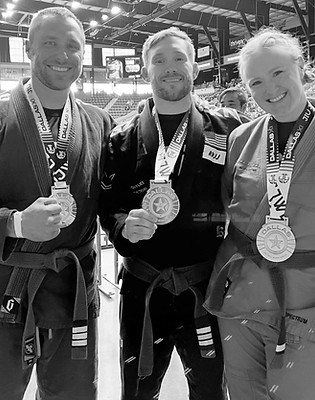 Adult Brazilian Jiu Jitsu competitors at BJJ tournament in Dallas, TX with gold medals