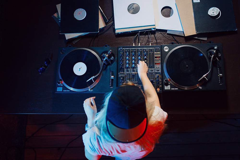 DJ turning knobs on turntables