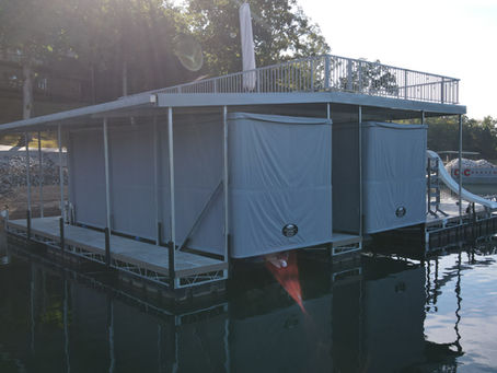 Boater using Touchless Boat Cover system at dock, pressing button for effortless protection