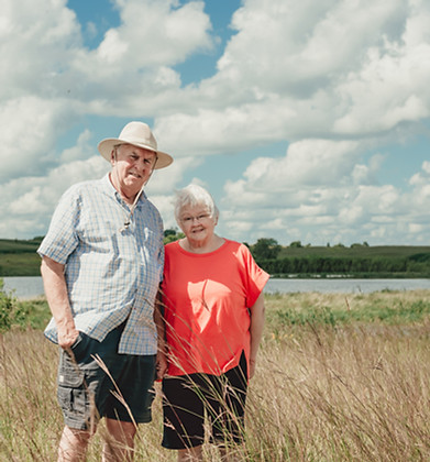 2025 Outstanding Conservationist stand in front of restored wetland