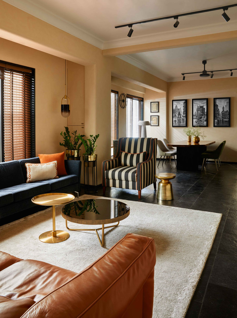 a living room with a striped chair and a couch