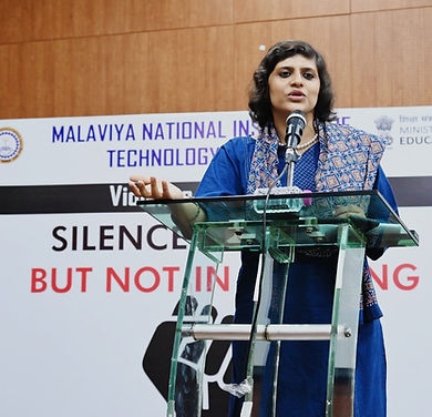 Dr Ritika Mahajan standing at the podium giving a lecture at MNIT Jaipur