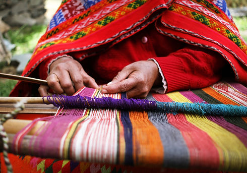 Indigenous artisan from Latin America weaving a Poncho by hand