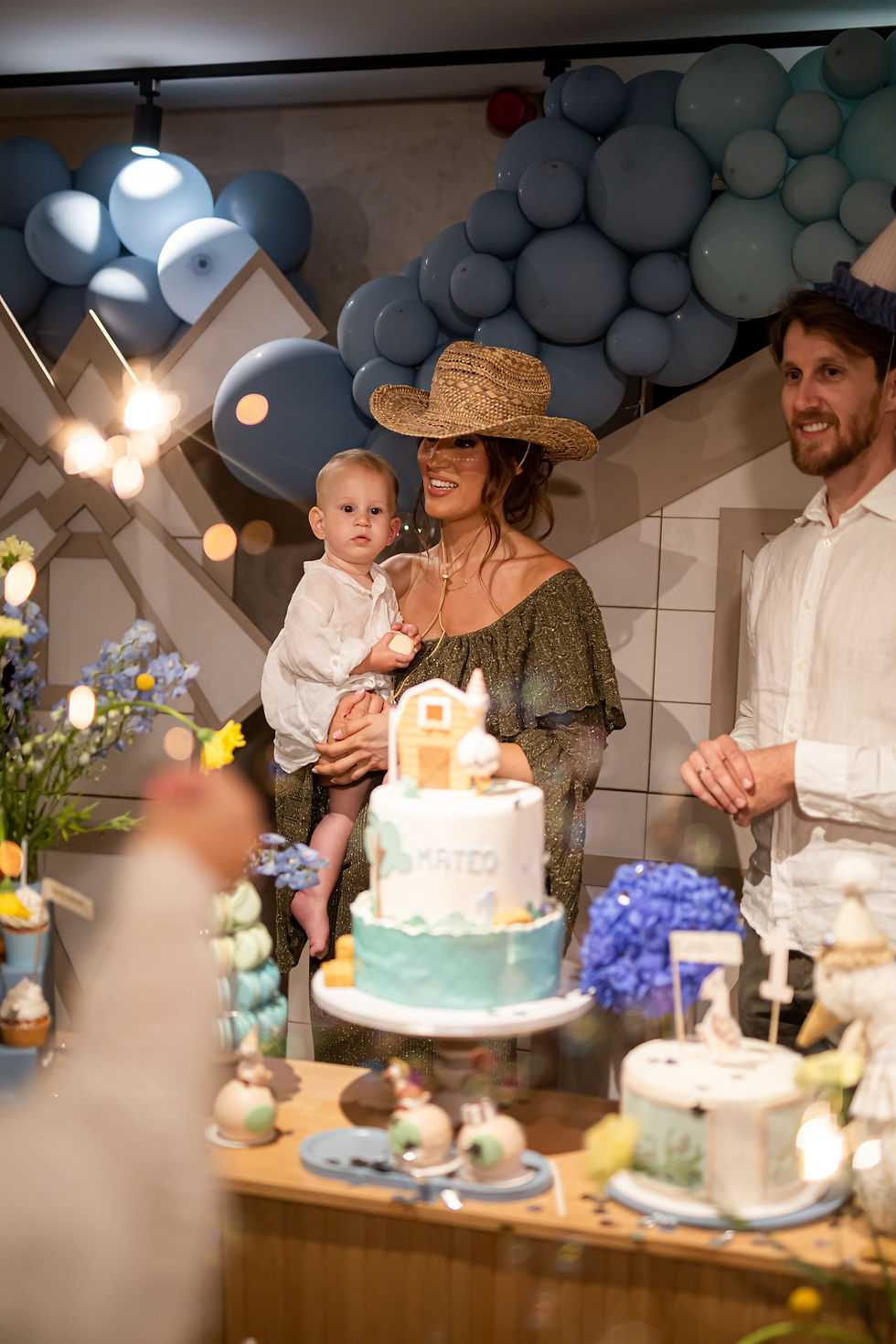 Family celebrating a child's birthday with a birthday cake