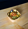 Bowl from Pepe’s Express with avocado, sweetcorn, crisps, etc., on wooden table