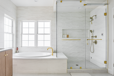 Large walk-in steam shower with textured white wave tiles, brushed gold fixtures including a slide bar and rain head, digital steam control, and a built-in soaking tub.