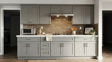 Modern transitional kitchen design featuring matte gray shaker cabinets with brass hardware, a warm wood-look tile backsplash, white quartz countertops, and a stainless steel gas cooktop.