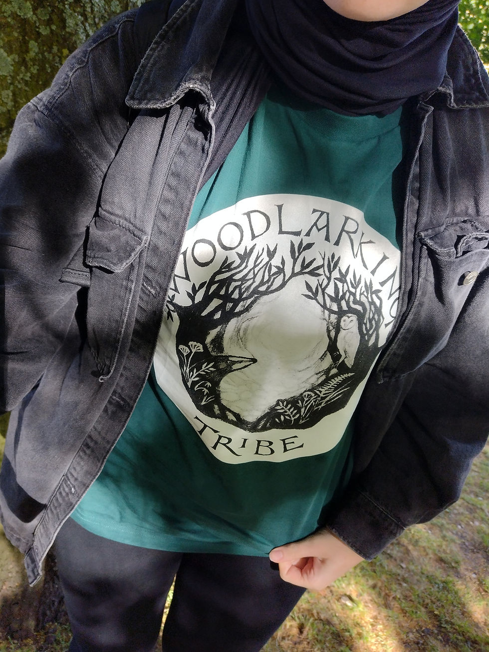 Woman wearing a rich green t-shirt with a Woodlarking Tribe design on the front