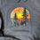 Thumbnail: Dark grey poly hoodie. Forest sunset with birds.