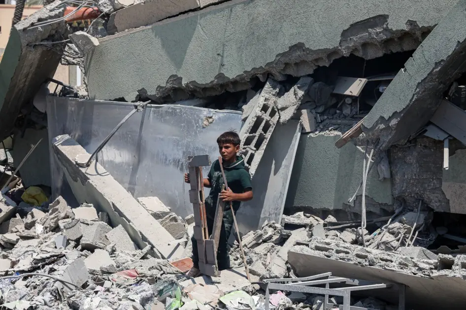 A boy stands on the rubble of Khadija School in Deir al-Balah, central Gaza, which an Israeli airstrike hit on July 27, 2024, killing at least 15 displaced Palestinians. © 2024 Rizek Abdeljawad/Xinhua via Getty Images