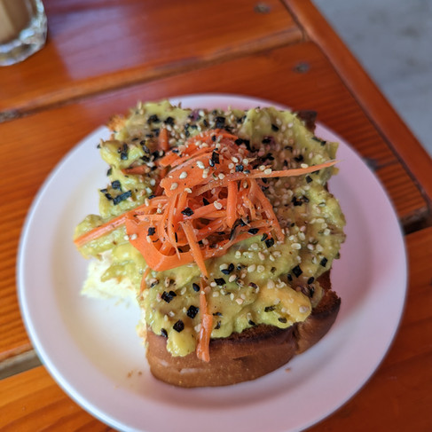 avocado toast with sesame seeds and carrots on top