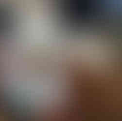 two poke bowels with rice shown in to-go container with two canned drinks in foreground