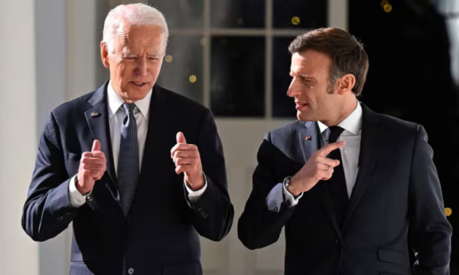 Sina United States (US) Pres. Joe Biden at French Pres. Emmanuel Macron - File-Jim Watson-The Associated Press