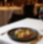 Elegant fine dining table setting with crystal glassware and candlelight in a warm, inviting atmosphere