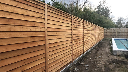 Trimmed Horizontal Fence on a chain wall adjacent to a residential pool