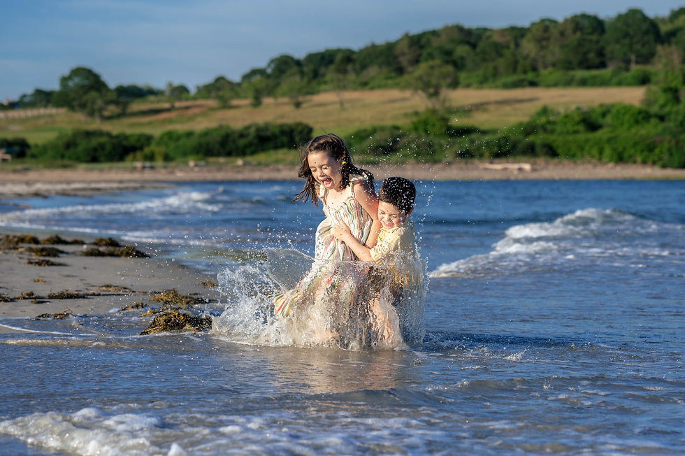 family on beach laughing