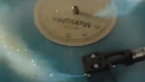 Spinning vinyl record with star dust