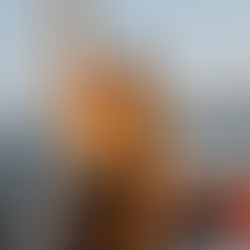 Julia C Woellner sits on a boat right arm in the sky, eyes closed