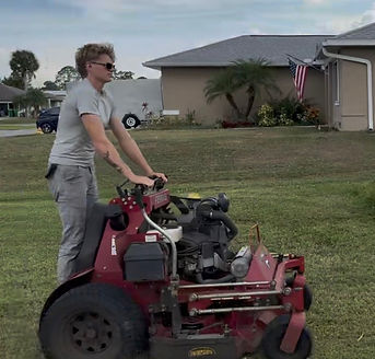 Employee cutting lawn in Gulf Cove FL