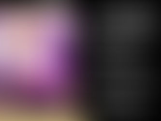 Two women in elegant dresses posing on a circular platform inside a brightly lit 360 video booth at a party. One woman wears a sparkling pink dress, and the other a white dress.