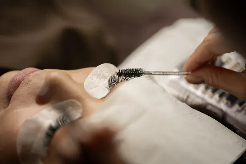Izumi Sugihara assessing natural lash health before applying eyelash extensions at En Beauty, Northcote Auckland