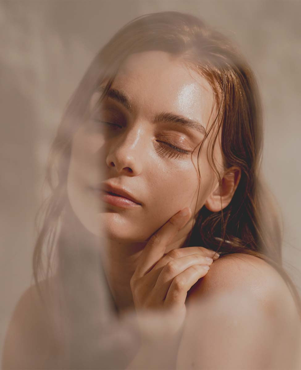 Soft-focus portrait of serene woman after En Beauty facial treatment