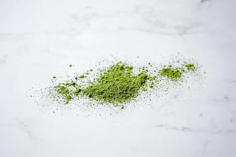 Fine ceremonial grade Japanese matcha green tea powder on a white surface