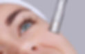 The cosmetologist makes the procedure Microdermabrasion of the facial skin of a beautiful,