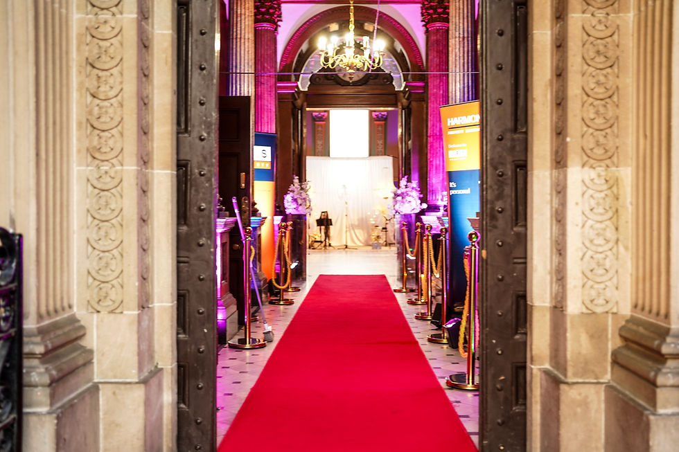 Gatsby Night entrance with red carpet and gold decorative arches