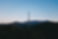 Cell tower in a mountainous landscape at dusk.