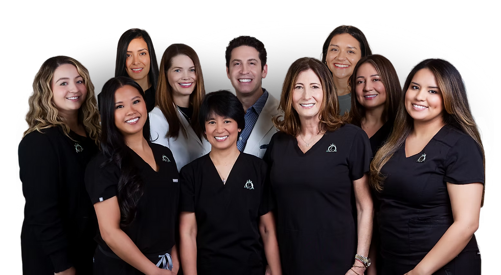 The dedicated clinical team at Lazare Biomimetic Dentistry & Smile Design, led by Dr. Marc Lazare, photographed together against a soft sage green background — a warm, professional group of specialists united by a shared commitment to exceptional patient care in New York City.