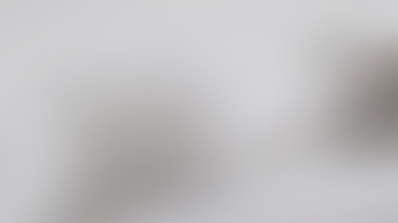 Close-up of a white toothbrush with whitening toothpaste containing glittery particles, symbolizing freshness and teeth whitening effects.